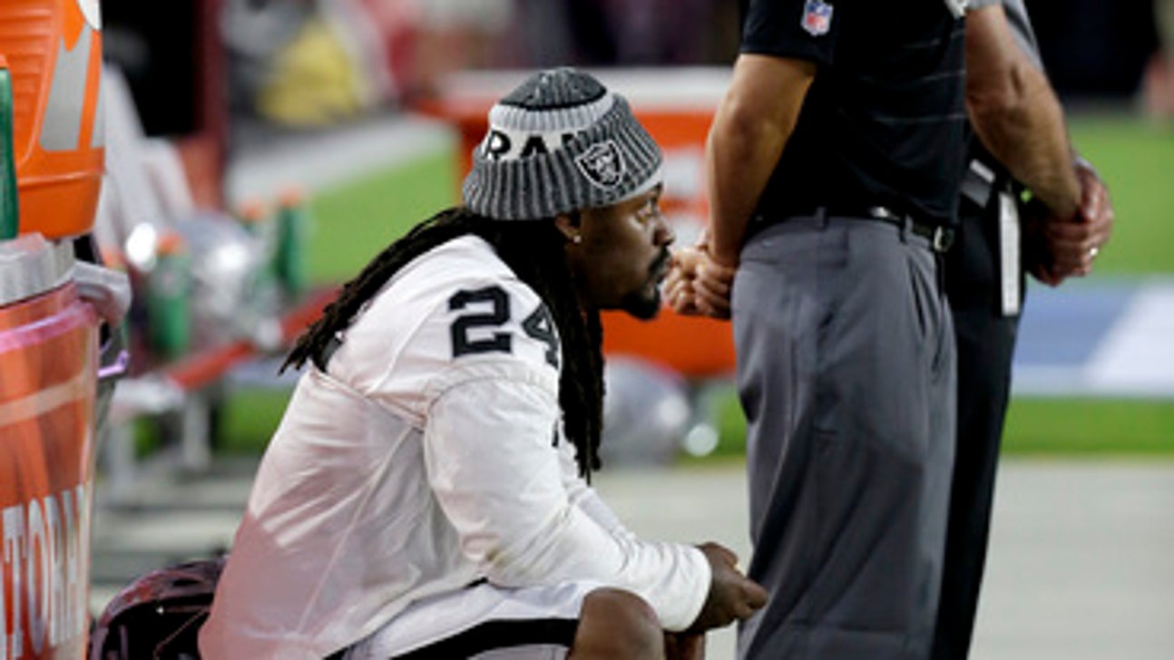 Raiders' Lynch sits during pregame anthem