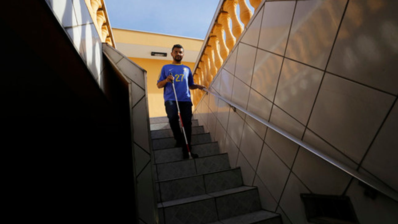 Brazil fan who is deaf, blind follows World Cup with help