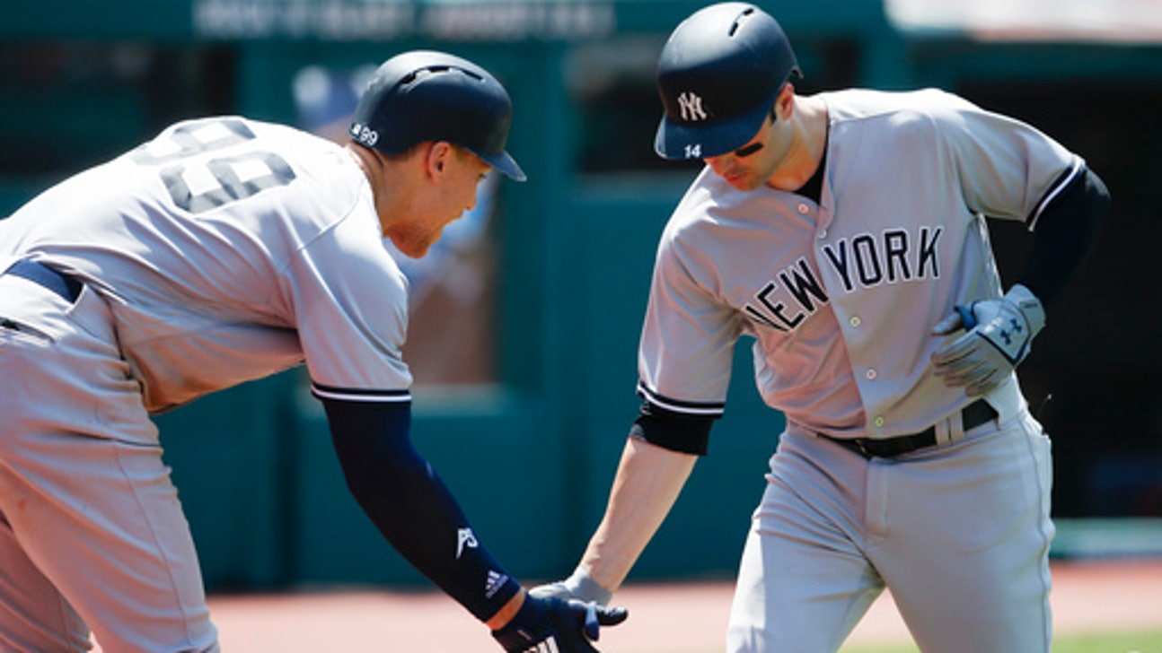 The Latest: MLB commissioner defends free agent signings