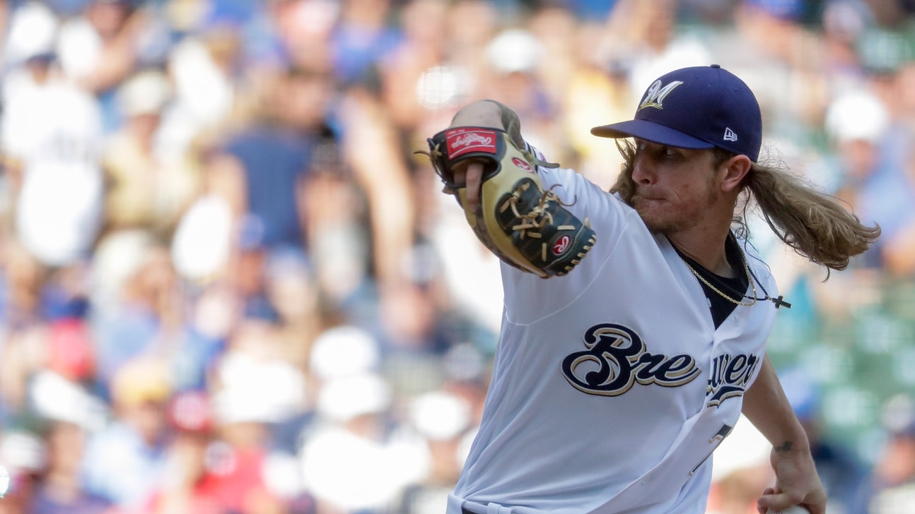 Grandal, Hader lift Brewers over Reds 5-4 to avoid sweep