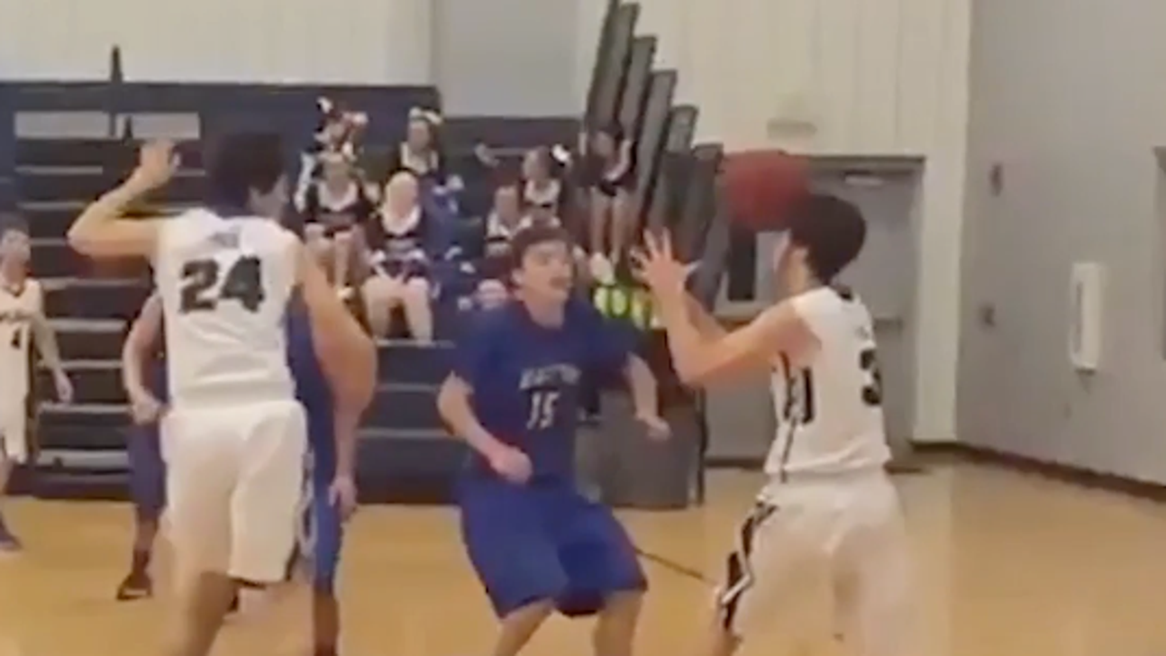 High school basketball player's pass ricochets off teammate's face into basket