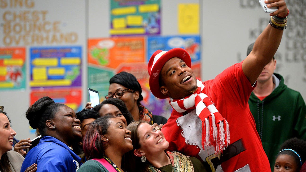 Cam Newton wears Santa costume, donates to the community