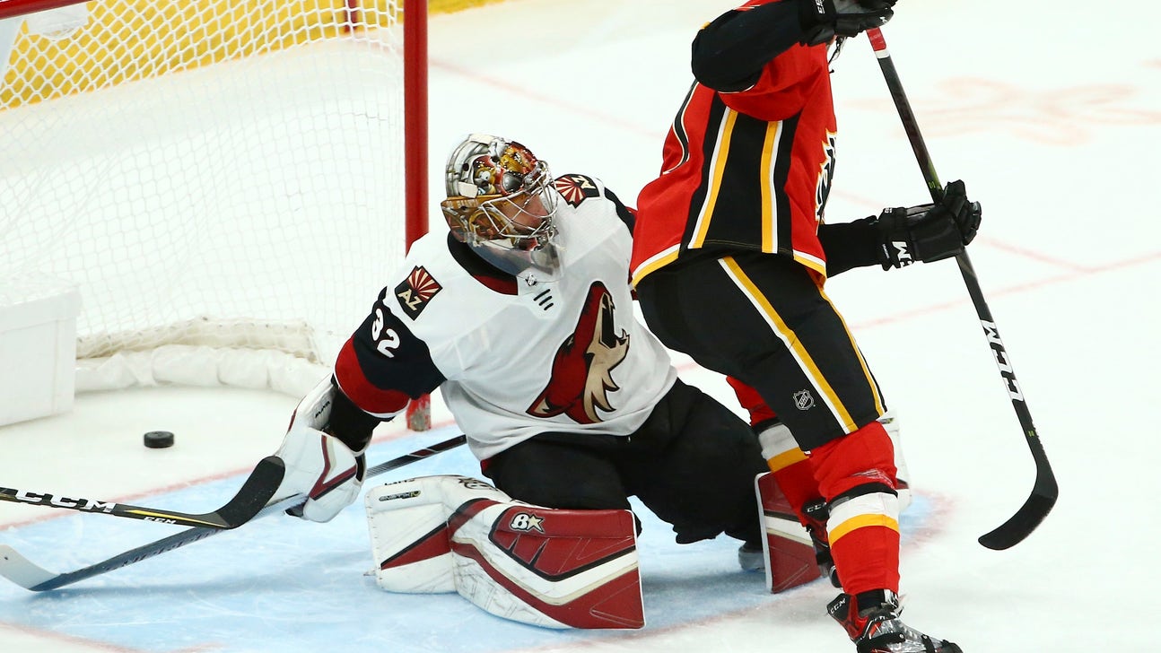 Coach hit by puck, Flames rout Coyotes 6-1