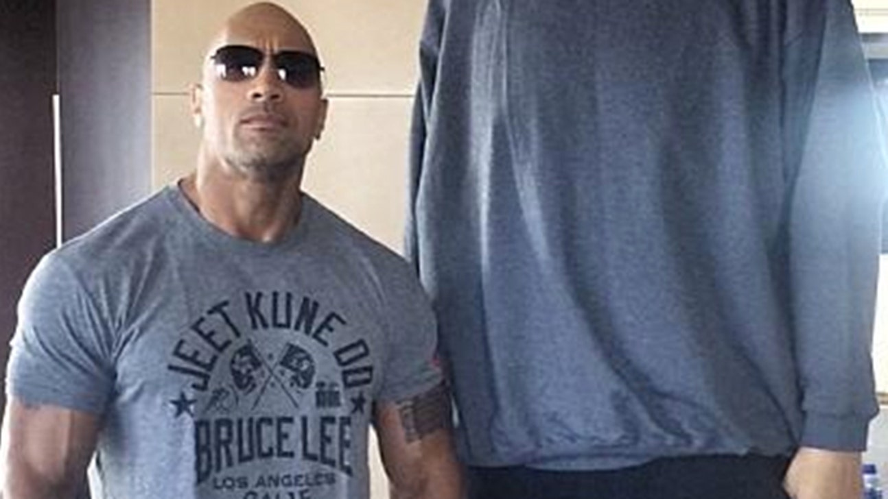 This is what the Rock looks like next to a 7-foot-9 basketball player