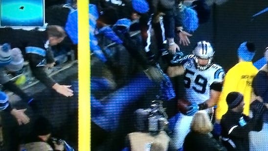 Fan falls out of stands after Luke Kuechly's pick-six touchdown for Panthers