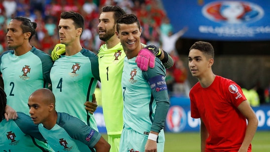 Best photobomb ever? Ball boy sneaks into Portugal photo, hugs Cristiano Ronaldo