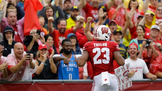 Taylor helps No. 13 Wisconsin trounce No. 11 Michigan 35-14