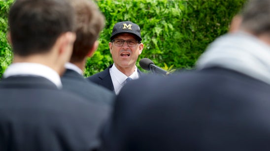 Harbaugh gives pope a helmet, pair of Jordans