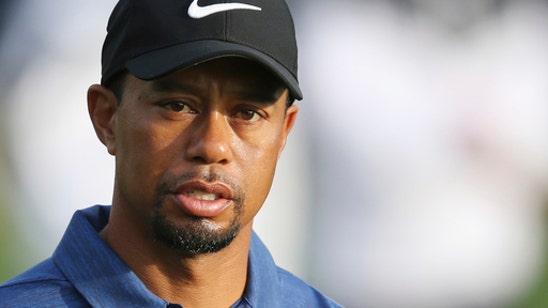 Woods back on the course in a cart, uncertain about future