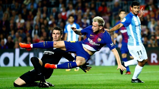 Barcelona holds off Malaga and regains cushion atop La Liga