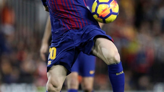 Barcelona salvages late draw to keep its lead over Valencia