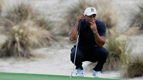 Tiger gets passing grade in 1st round in 10 months