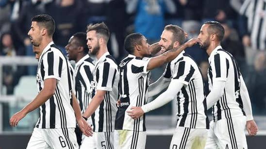 Juventus beats Genoa 1-0 to trail Napoli by 1 point