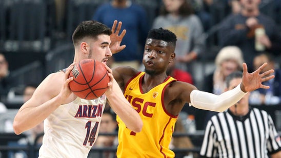 No. 15 Arizona beats USC 75-61 to defend Pac-12 title.