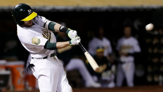Lowrie’s two-run double in 7th lifts A’s past Rangers 3-1