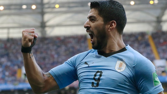 Suarez scores as Uruguay and Russia advance at World Cup