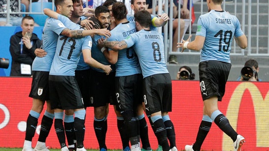 Suarez scores again and Uruguay downs host Russia 3-0