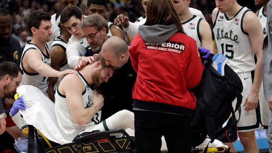 Michigan State’s Ahrens taken from court with leg injury
