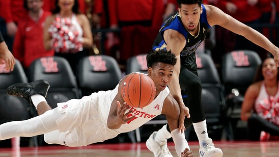 Davis scores 21 points, No. 19 Houston beats Tulsa 74-56