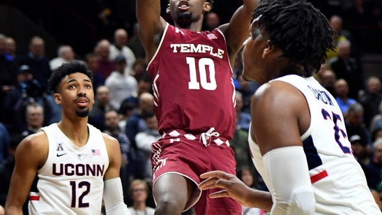 Alston leads Temple past UConn to keep tourney hopes alive.