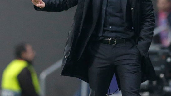 UEFA charges Atletico coach Simeone for obscene gesture
