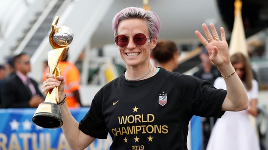 The Latest: Rapinoe, US team shows off World Cup trophy