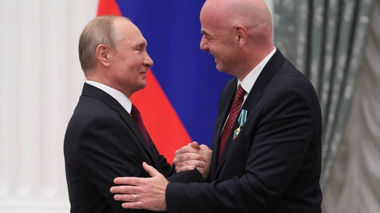 Putin awards medal to FIFA president Infantino