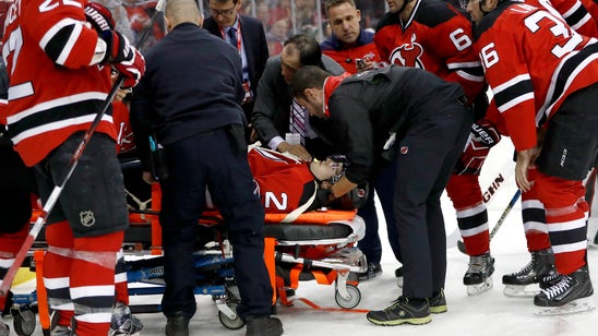 Video: Devils defenseman John Moore leaves ice on stretcher after hit from behind
