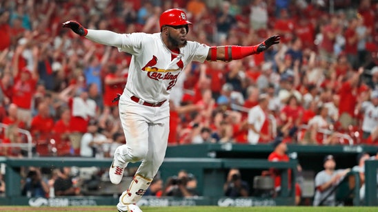 Ozuna's 4 RBIs, throw to plate lift Cards over Nats 4-2