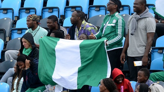 Nigeria fans pack stadium, watch from light posts and scoreboard