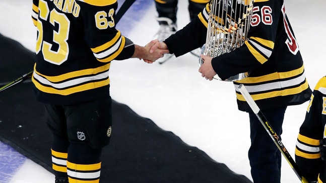 Red Sox bring World Series trophy to Bruins game