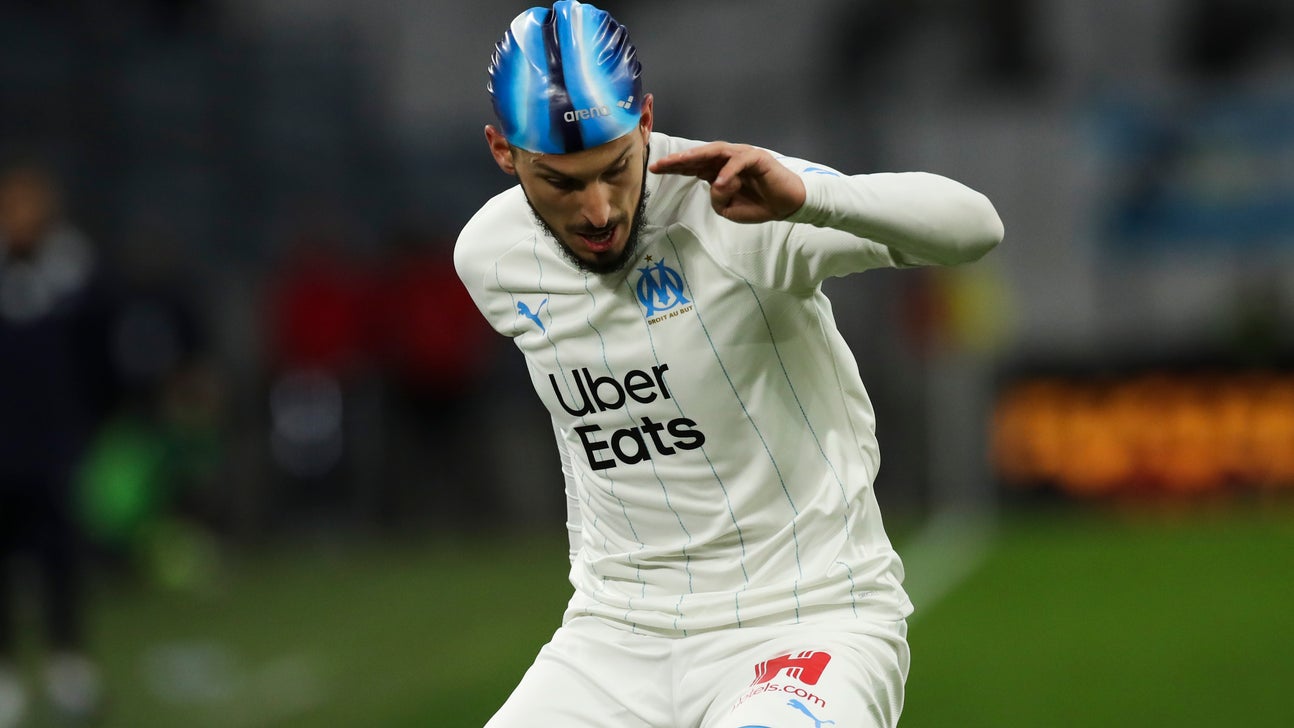 Marseille striker Benedetto wears swim cap after head injury