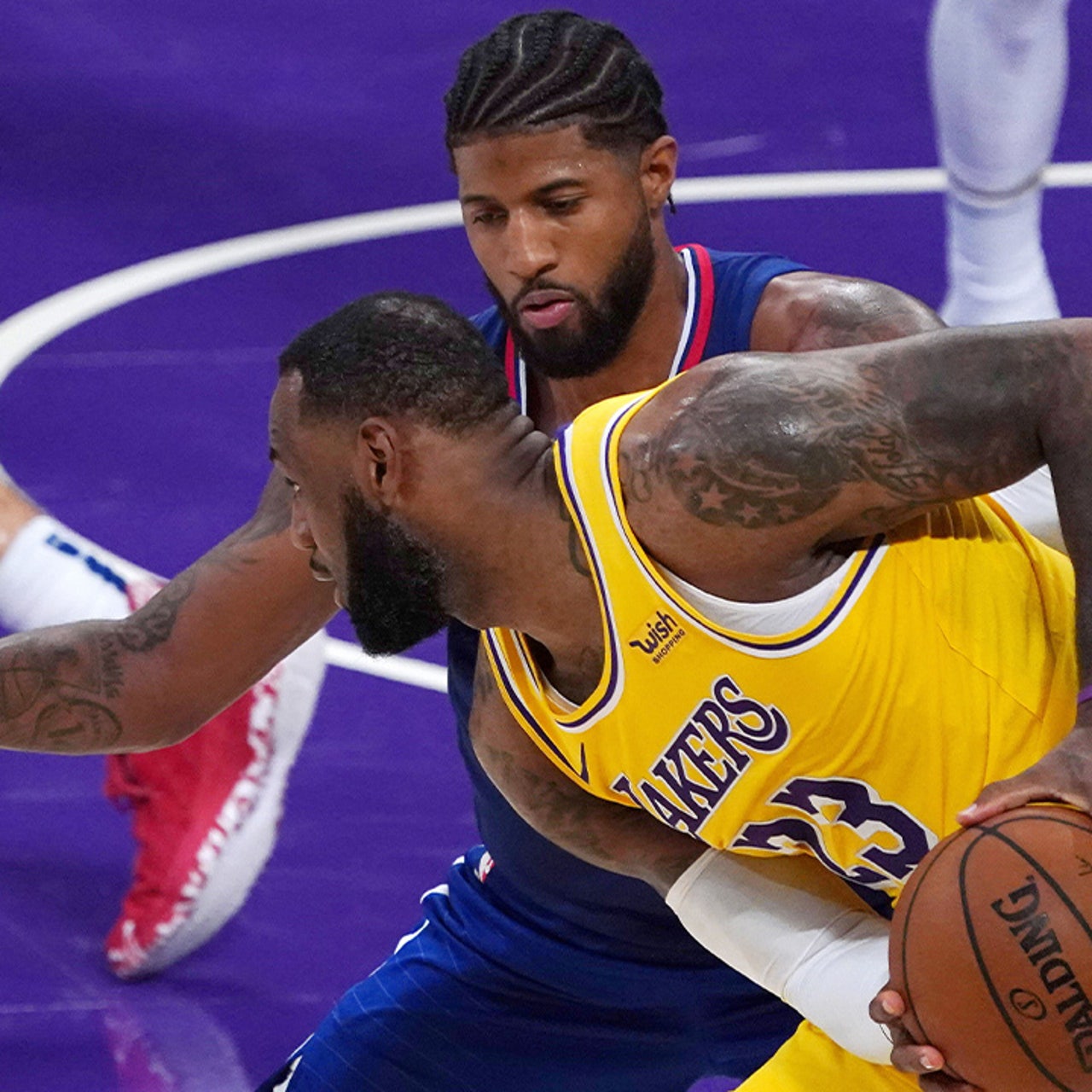 Los Angeles Clippers forward Paul George (L) is defended by Golden