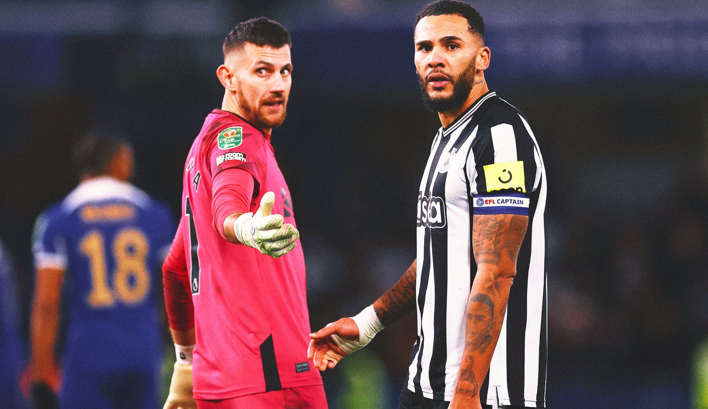 Newcastle GK Martin Dubravka confronted by a fan on the field at Chelsea