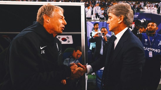 Saudi Arabia coach Roberto Mancini walks off while losing to Jurgen Klinsmann, South Korea in penalties