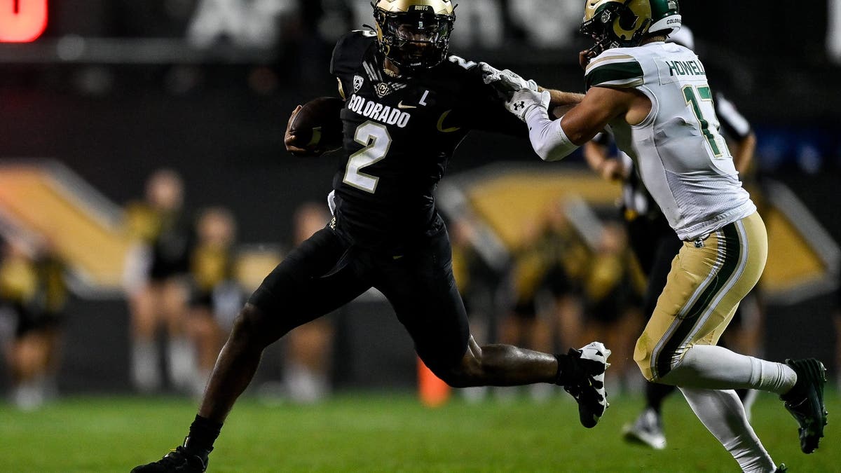 Shedeur Sanders stiff-arms an opponent during last season's Colorado win over Colorado state. (Photo by Dustin Bradford/Getty Images)