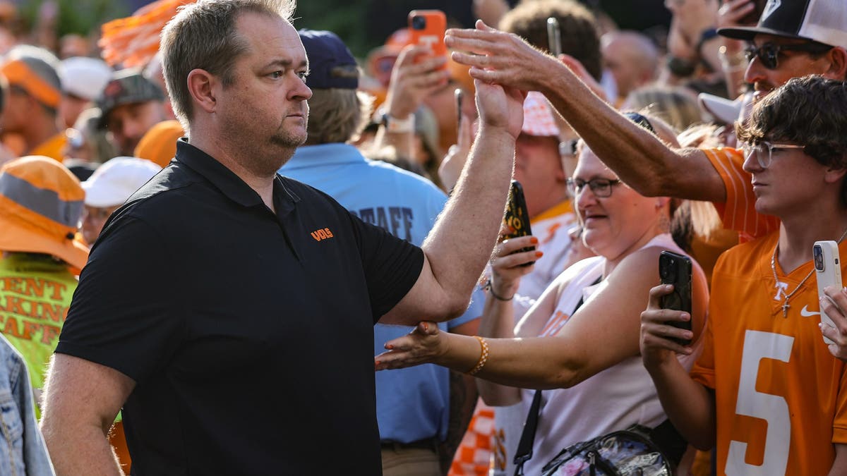 Tennessee head coach Josh Heupel high fives a fan during the Vols Walk prior to kickoff against Kent State on Sept. 14. (Photo by Brandon Sumrall/Getty Images)