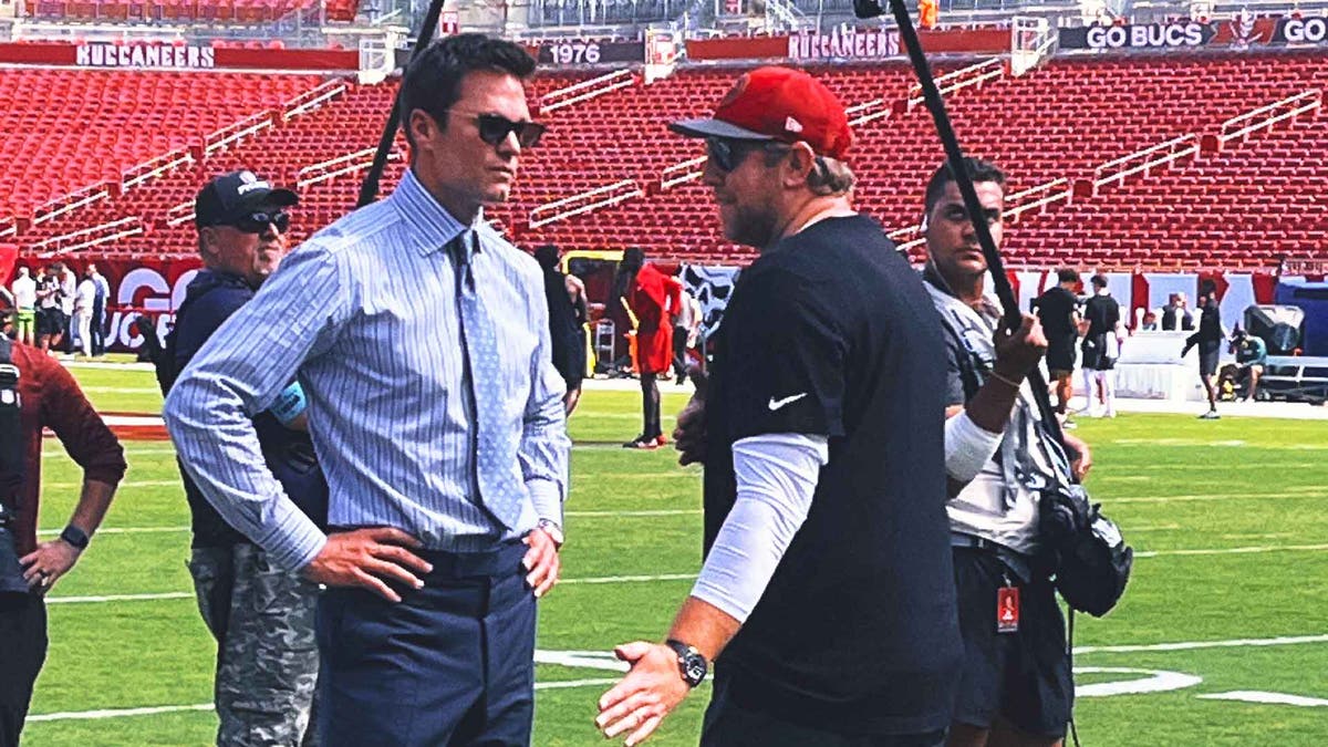 Tom Brady chats with Tampa Bay Buccaneers offensive coordinator Liam Coen before Sunday's game. (Photo by Richie Zyontz)