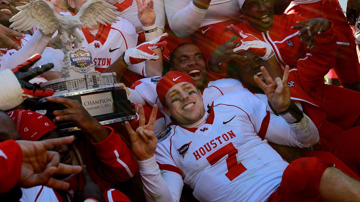 Case Keenum's record-setting seaon helped Houston's turnaround in 2011, which included a win over Penn State in the Ticket City Bowl. (Photo by Ronald Martinez/Getty Images)