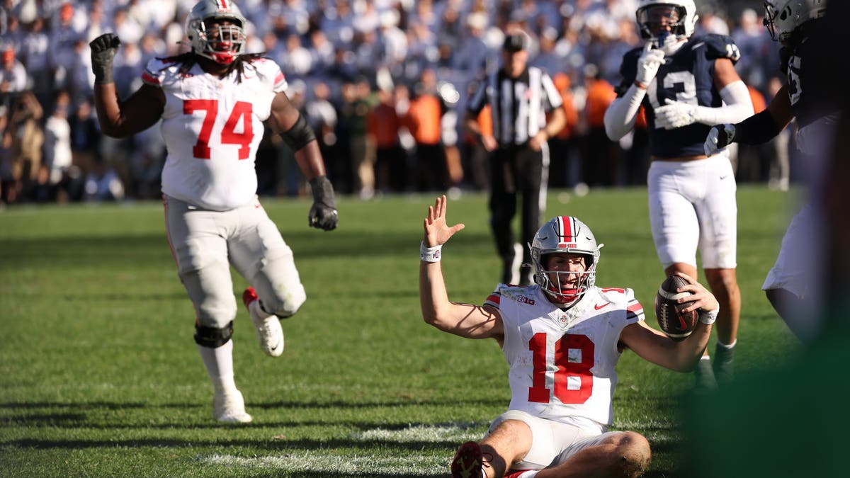 Ohio State QB Will Howard slides for a first down to secure the Buckeyes' 20-13 win over Penn State. (Photo by Scott Taetsch/Getty Images)