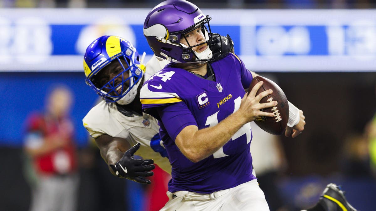 The Rams grabbed Sam Darnold's facemask before he was sacked in the end zone. (Photo by Ric Tapia/Getty Images)