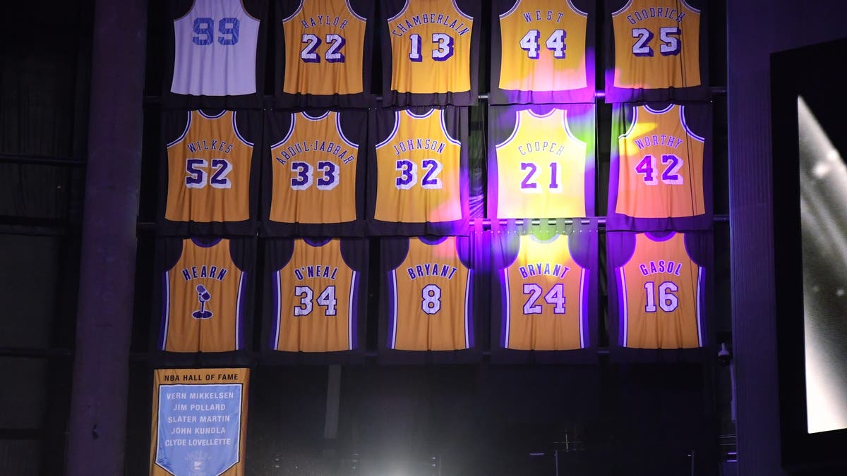Michael Cooper's No. 21 jersey now hangs between Magic Johnson's No. 32 and James Worthy's No. 42. (Photo by Allen Berezovsky/Getty Images)