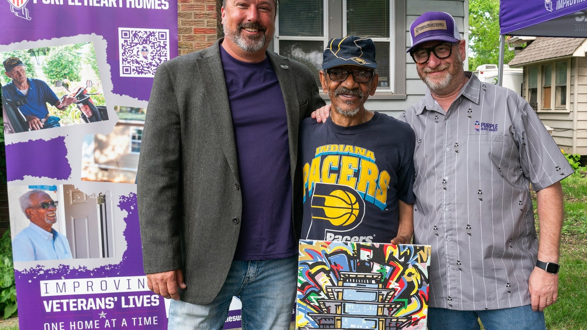 Kevin Smith (middle) was one of the four veterans who had his home repaired through FOX Sports and Purple Heart Homes' initiative.?