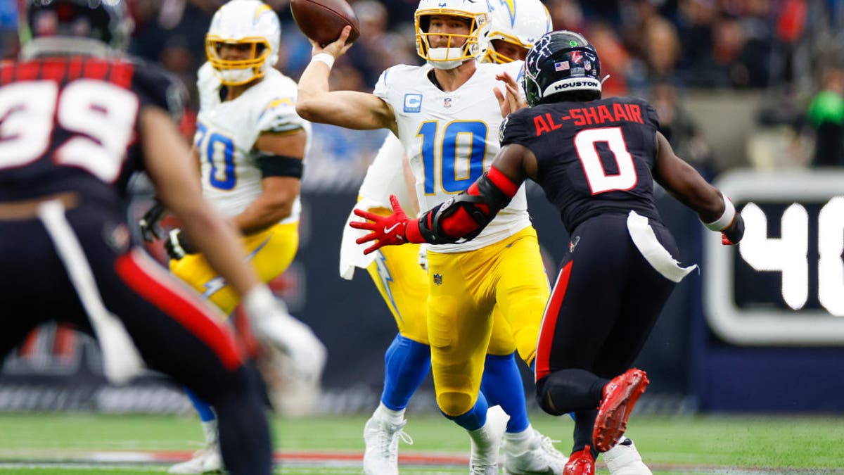 In a 32-12 loss to the Texans in the wild-card round, Justin Herbert threw four interceptions, more than he threw in the entire regular season. (Photo by Brandon Sloter/Getty Images)