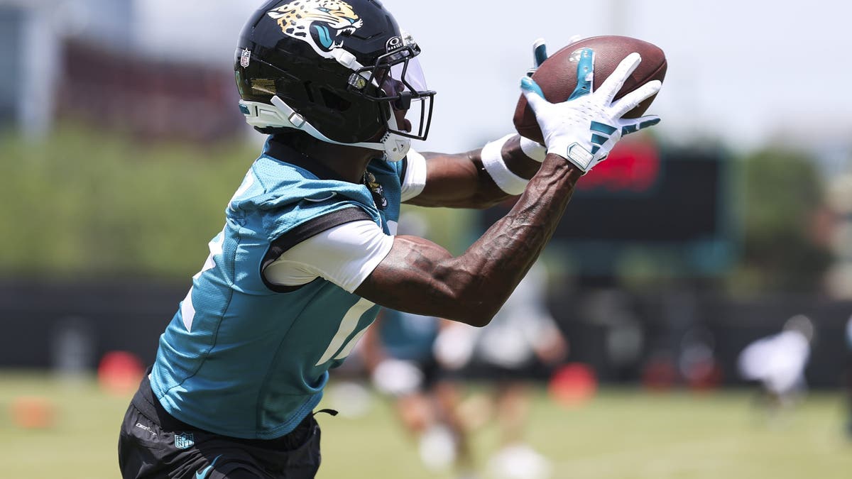 Travis Hunter #12 of the Jacksonville Jaguars catches a pass during an NFL football practice at Miller Electric Center on May 19, 2025 in Jacksonville, Florida. (Photo by Logan Bowles/Getty Images)
