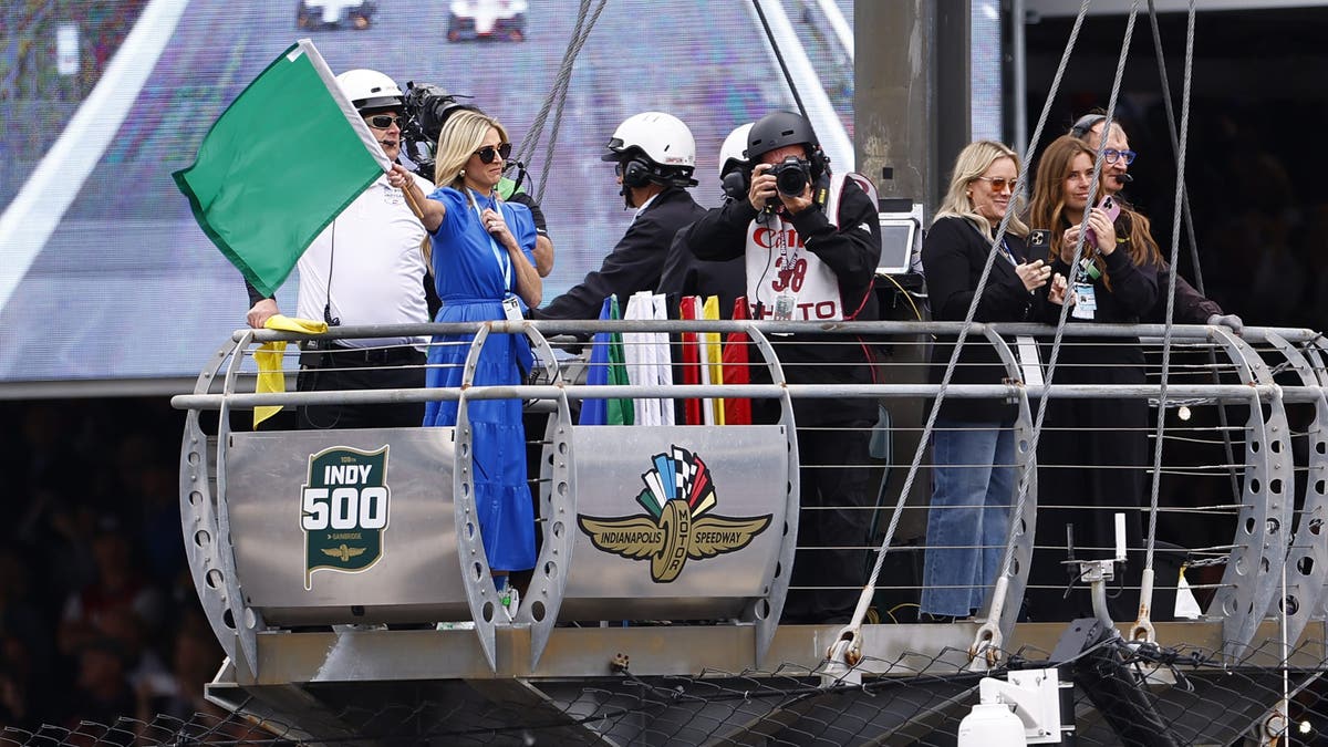 Casey Irsay Foyt waves the green flag to start the 109th Running of The Indianapolis 500 at Indianapolis Motor Speedway.