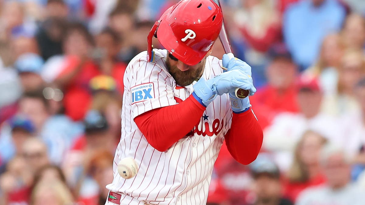 Bryce Harper is hit in the elbow by a pitch during the first inning of the game against the Atlanta Braves.