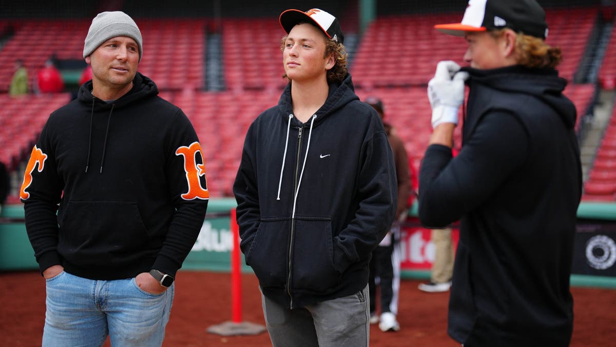 Ethan Holliday stands in the middle of his father Matt Holliday and Jackson Holliday. (Photo by Daniel Shirey/MLB Photos via Getty Images)