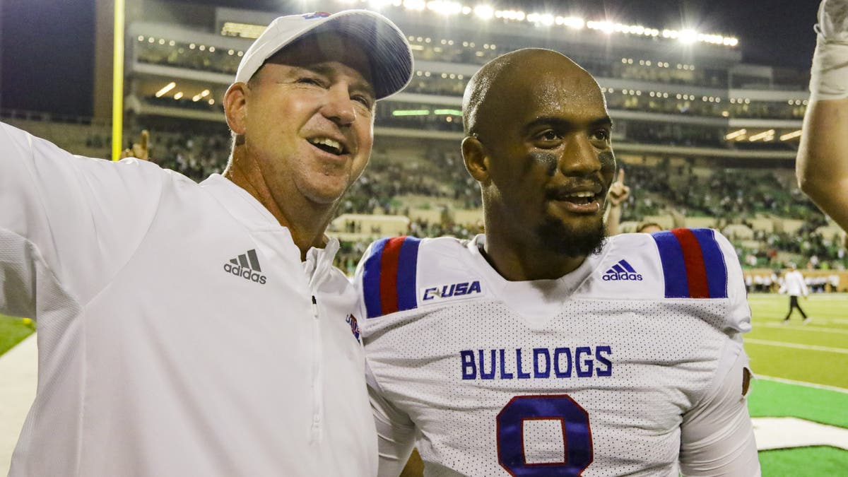 Louisiana Tech head coach Skip Holtz and quarterback J'Mar Smith (8) celebrate a win over North Texas on September 29, 2018. (Photo by Matthew Pearce/Icon Sportswire via Getty Images)