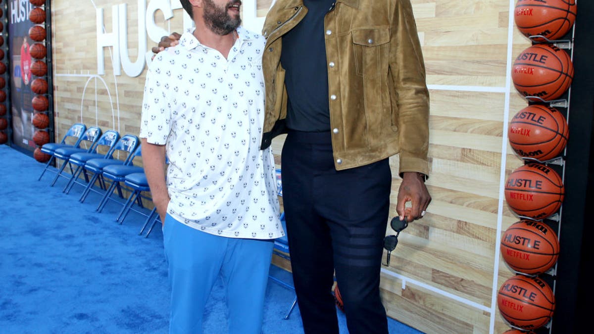(L-R) Adam Sandler and LeBron James attend the Netflix World Premiere of "Hustle" at Regency Village Theatre on June 01, 2022 in Los Angeles, California. Sandler and James each had a role in producing the film, and Sandler starred in it.